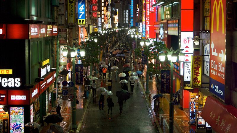 People with Umbrellas on Street — Red