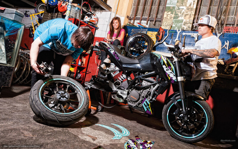 People working on a motorcycle