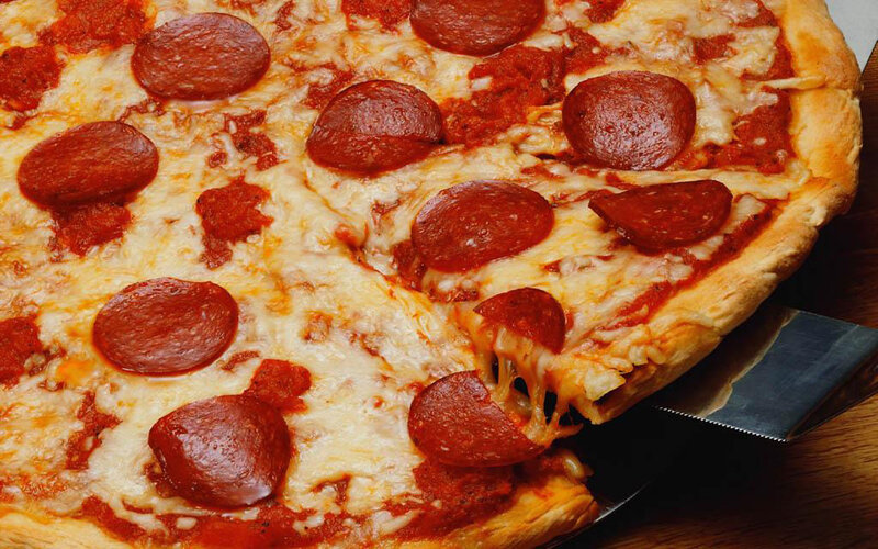 Pepperoni pizza on wooden board