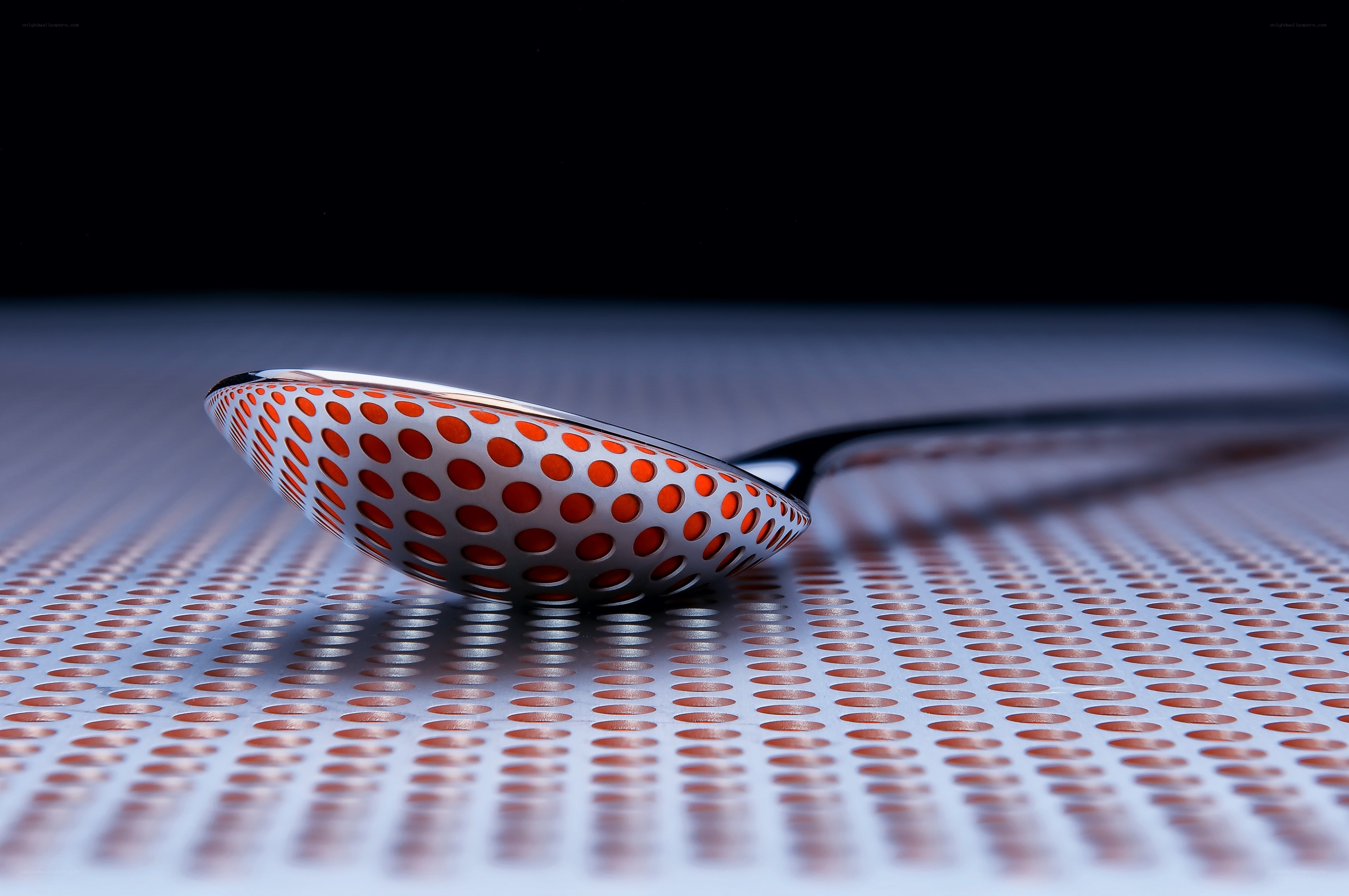 Perforated spoon on metal surface