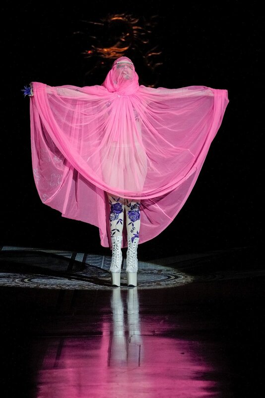 performer in pink cape