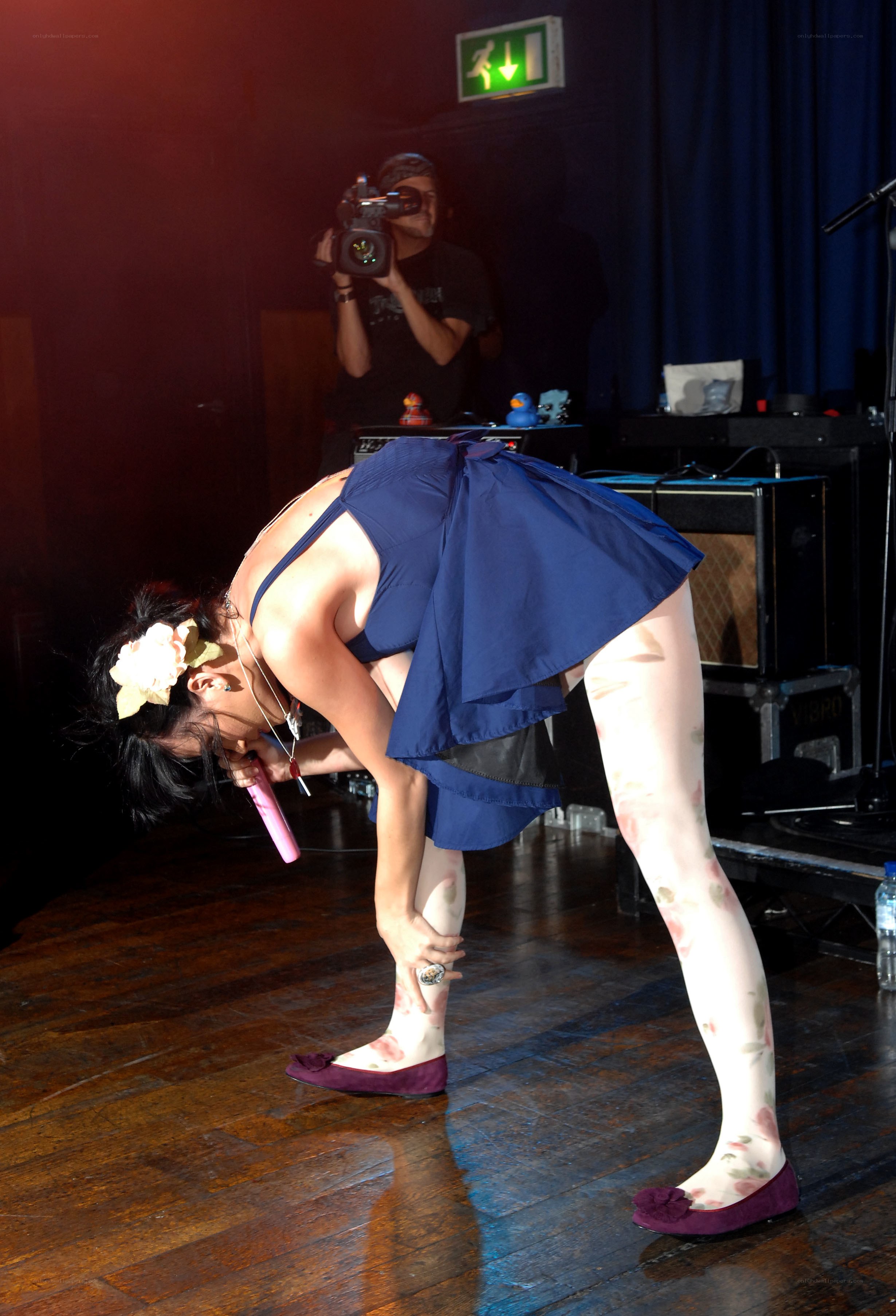 Performer on stage bending over