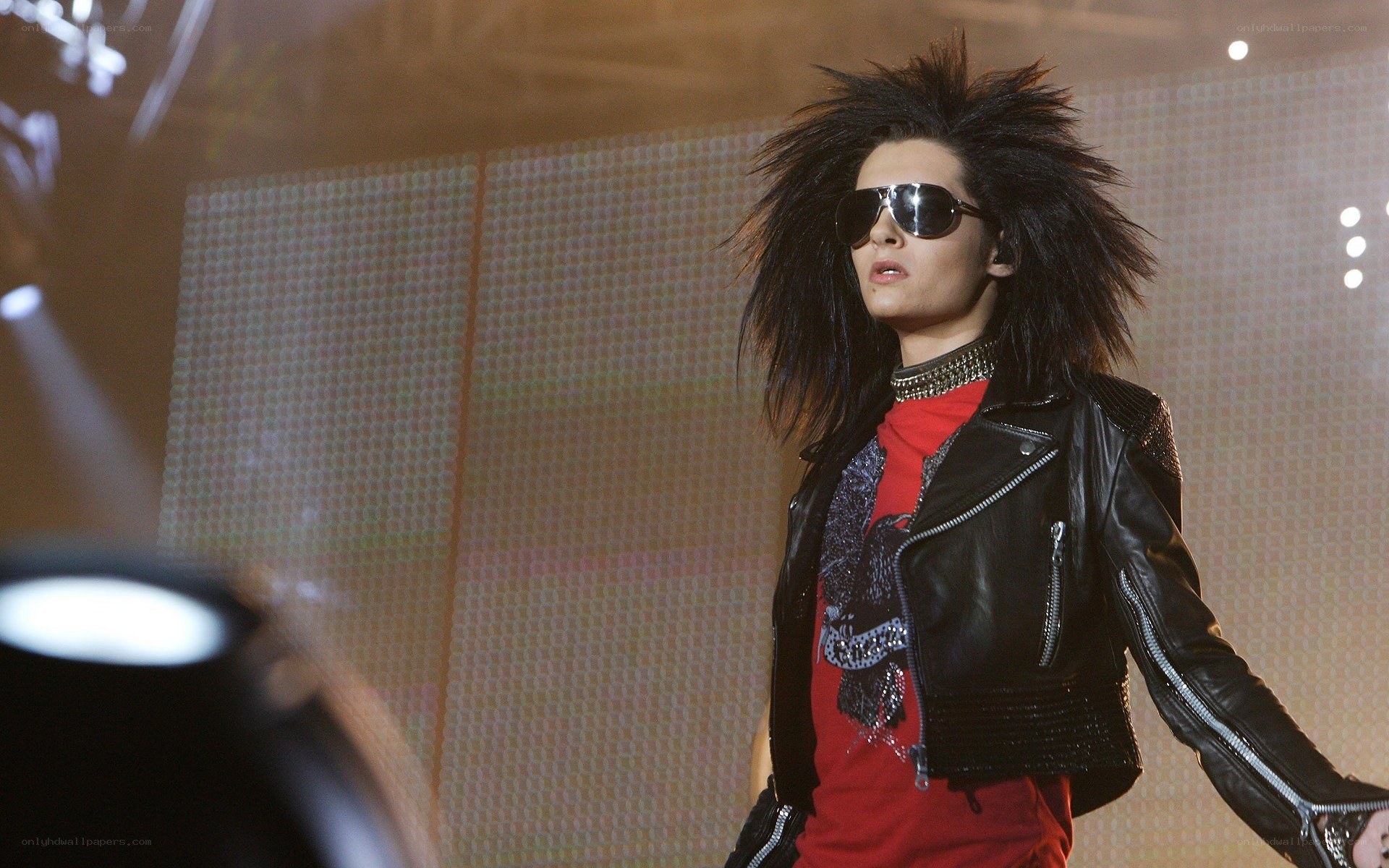 performer on stage in leather jacket