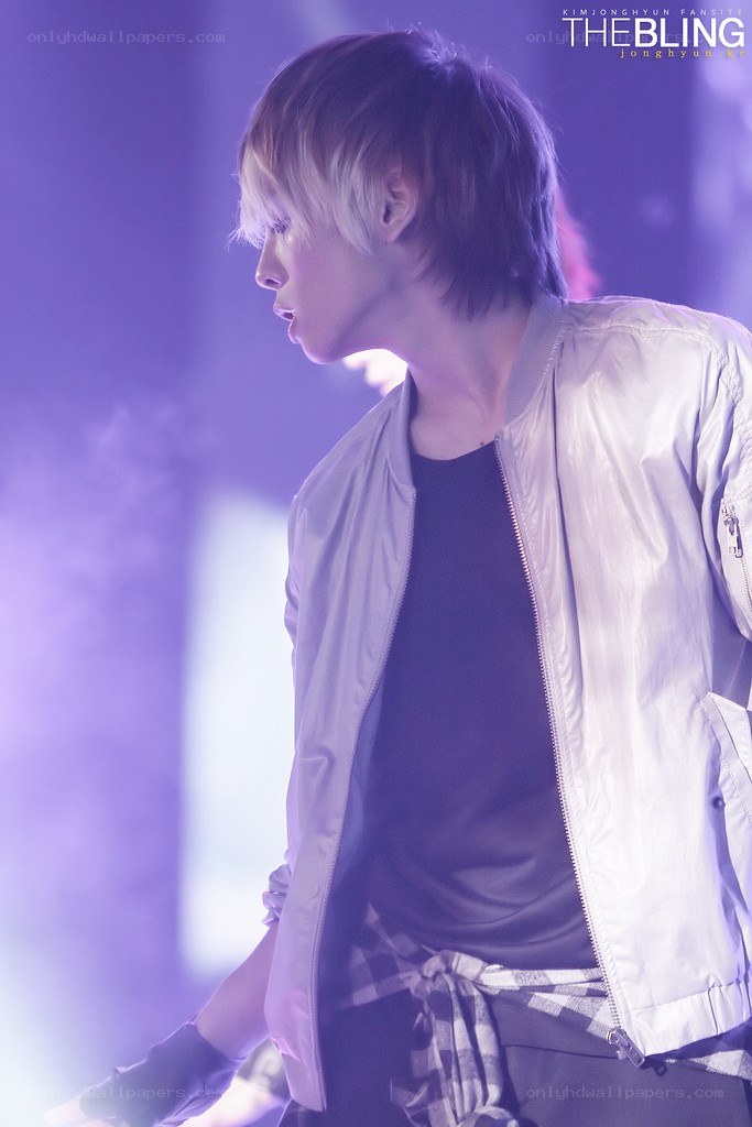 performer on stage in purple light