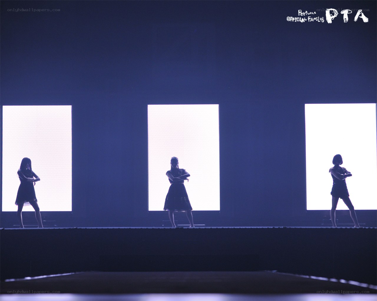 Performers on a dark stage