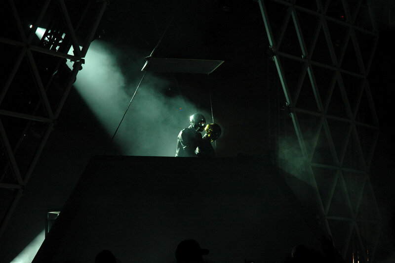 Performers on a dark stage