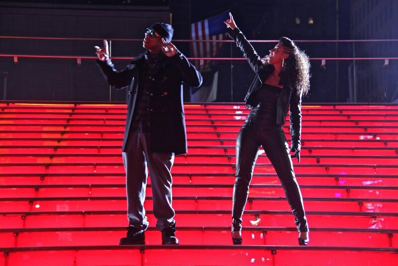 Performers on a red-lit stage