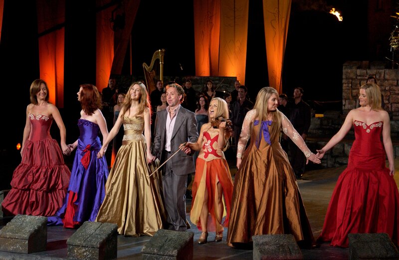 Performers on stage in formal gowns