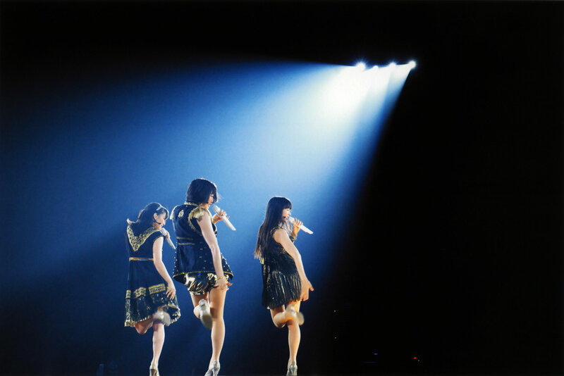 Performers on stage under spotlight