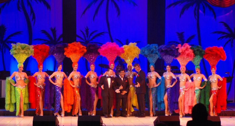 Performers on stage with feather headdresses