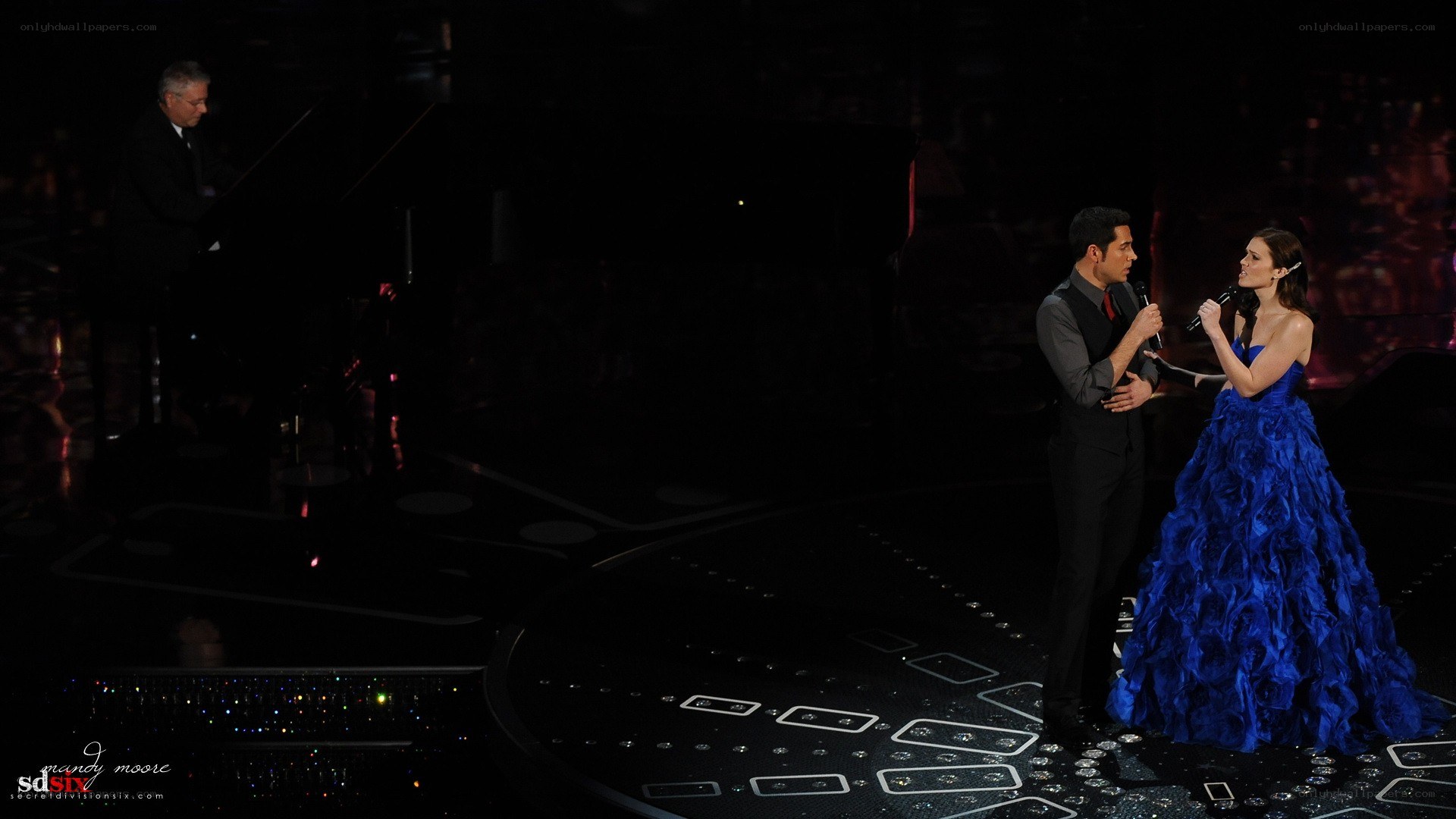 Performers on stage with piano