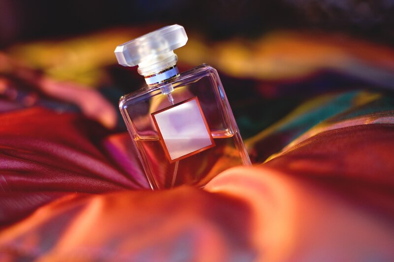 Perfume bottle on colorful fabric