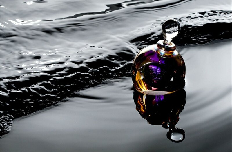 Perfume bottle on water surface