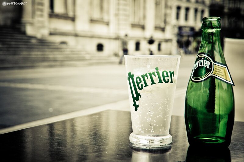 Perrier bottle and glass on a table