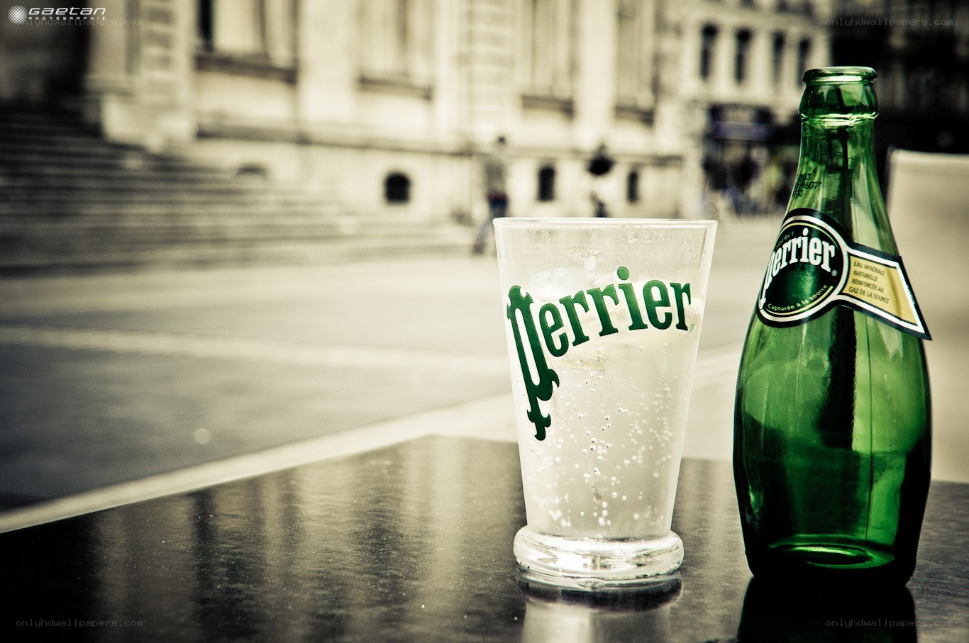 Perrier bottle and glass on a table