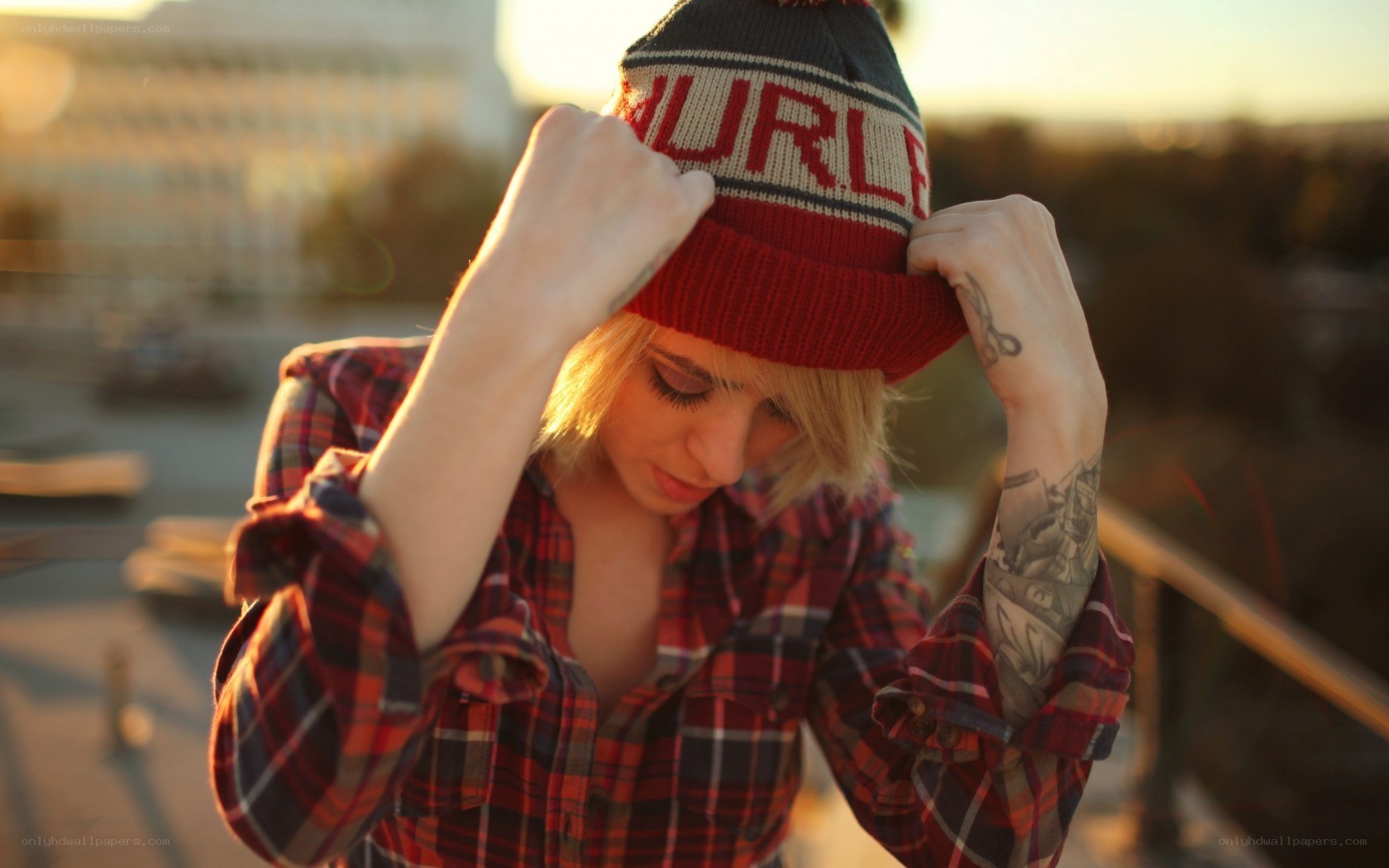 person adjusting beanie hat