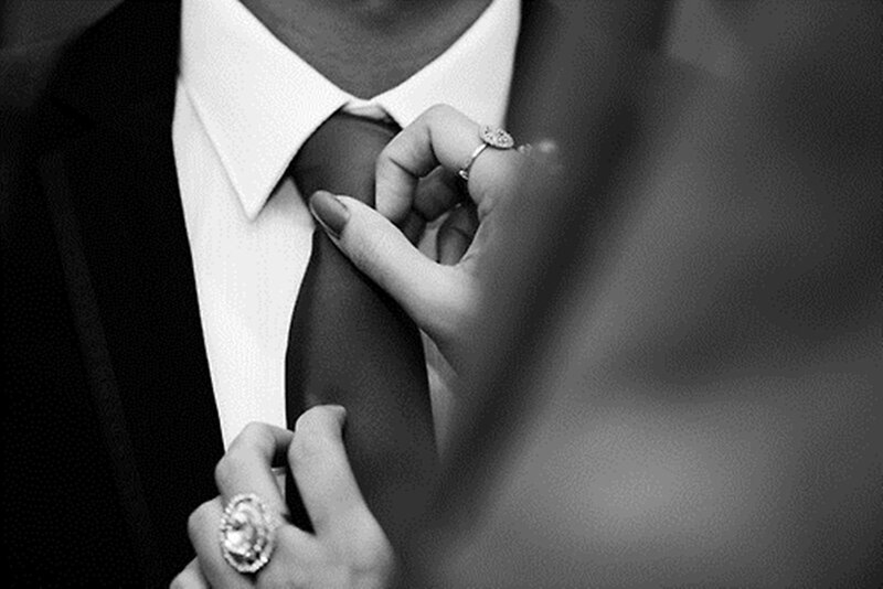 Person Adjusting Tie — Black