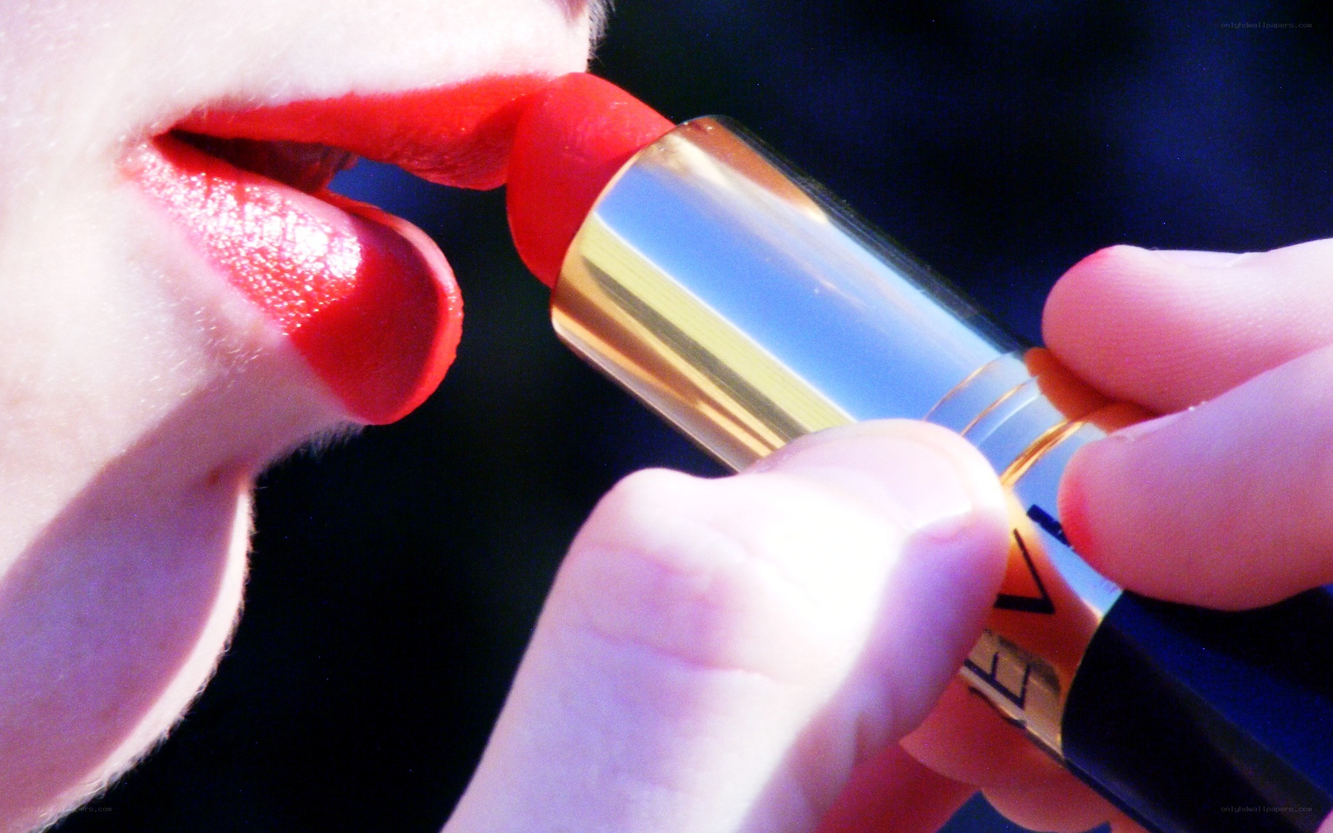 person applying red lipstick
