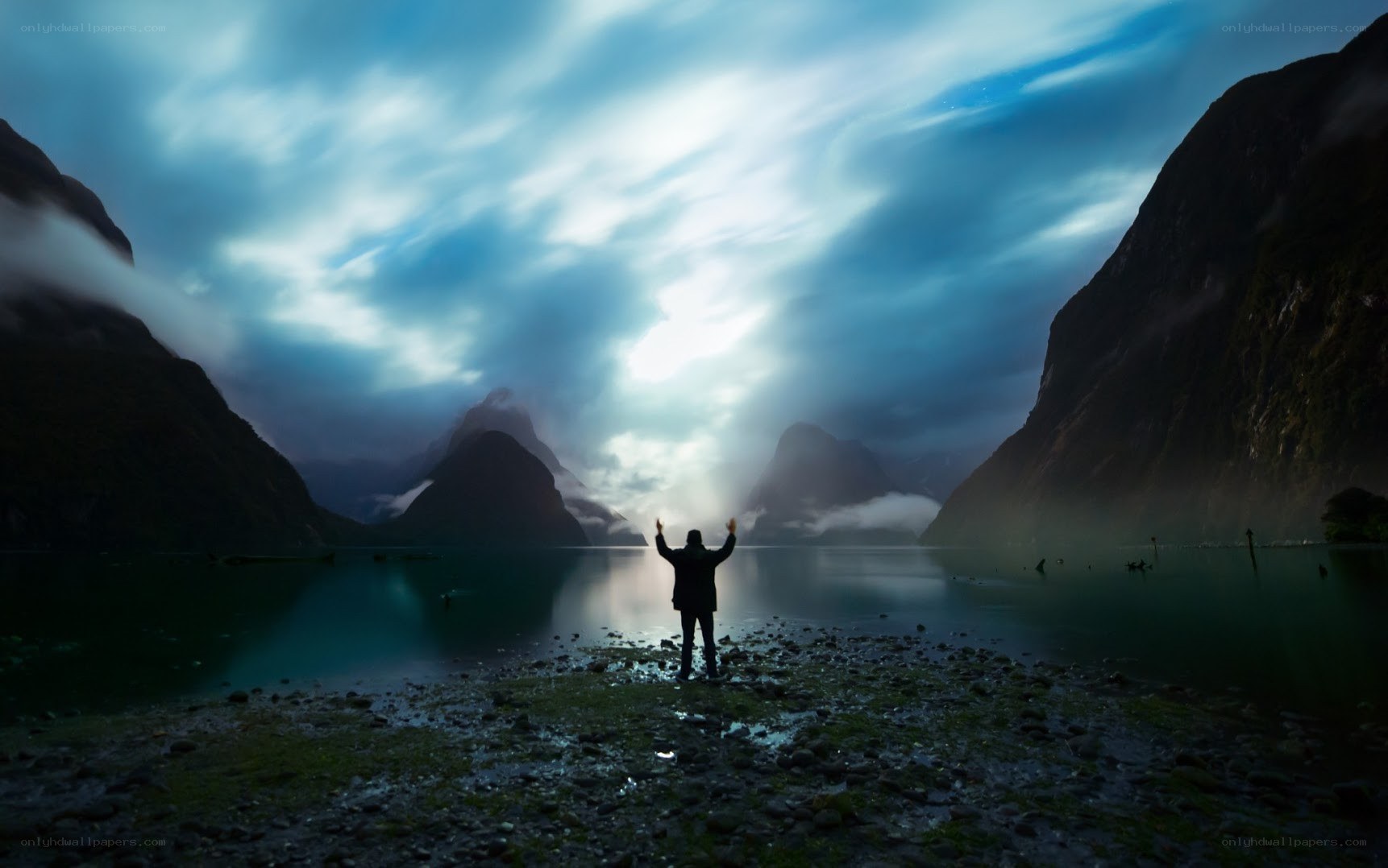 Person at a lake with mountains
