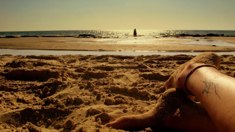 person at beach with tattoo