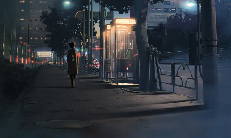 person at bus stop at night