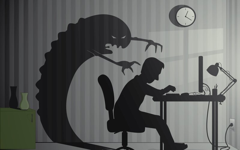 person at computer with shadow monster