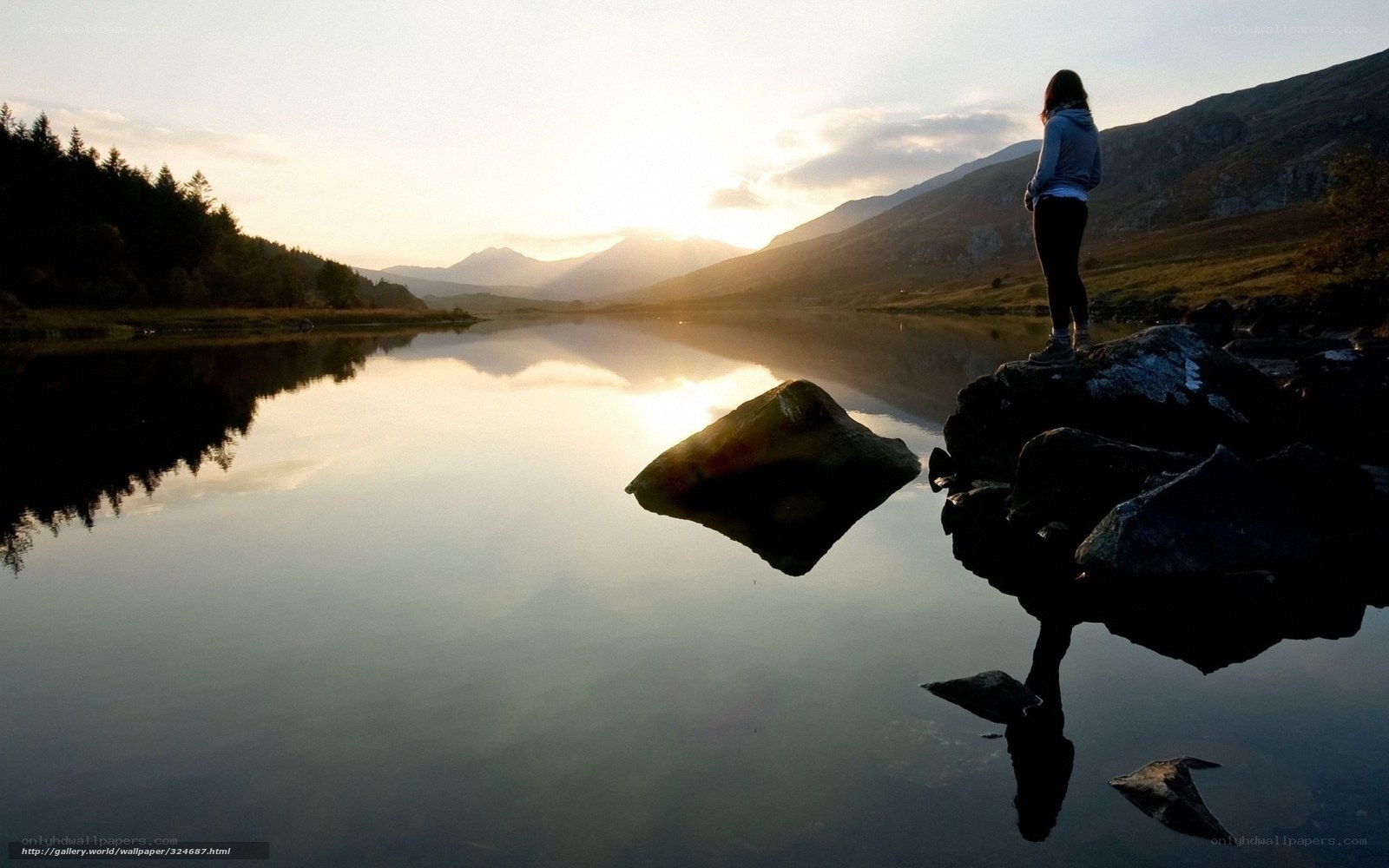 person at lake at sunset