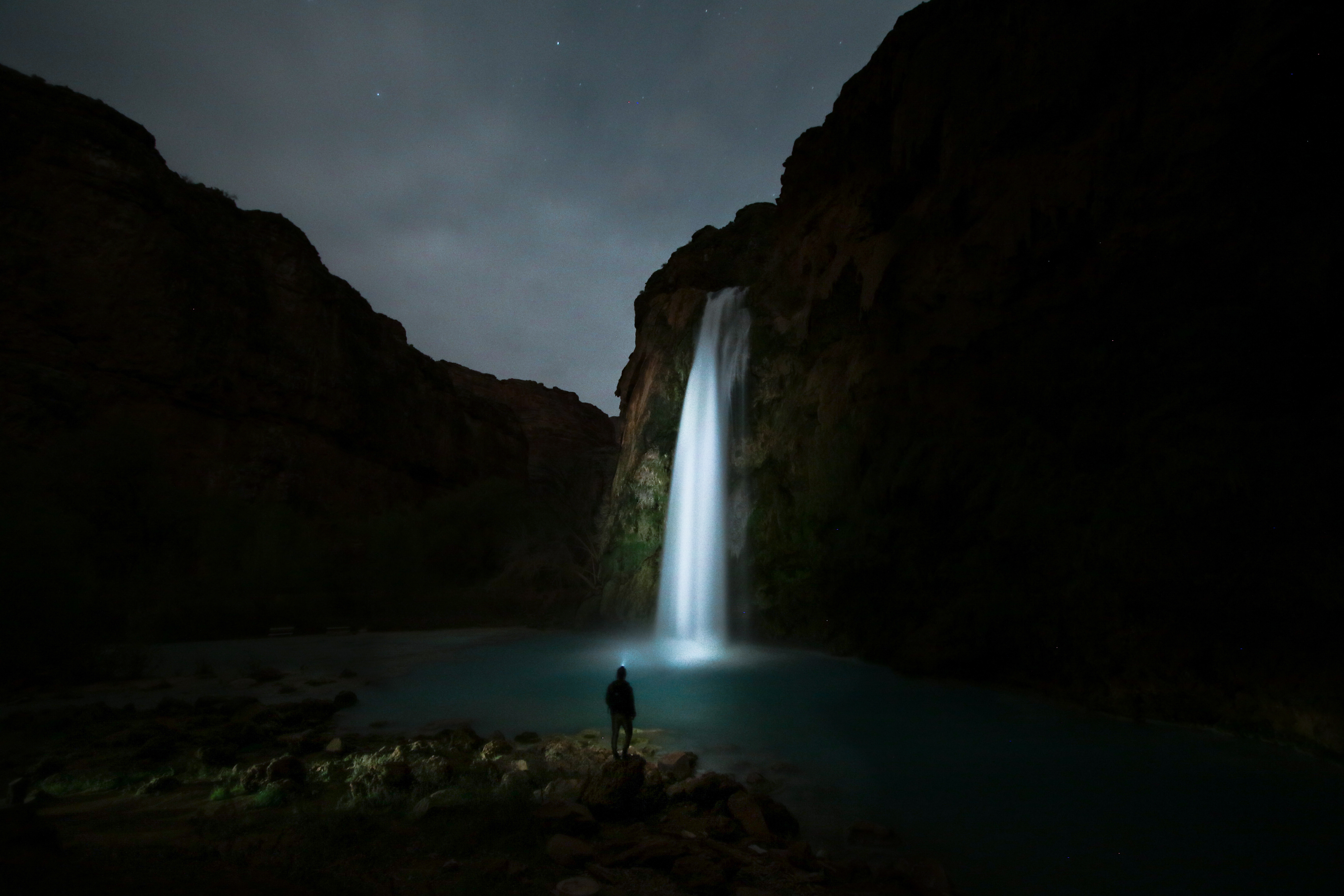 Person at night waterfall