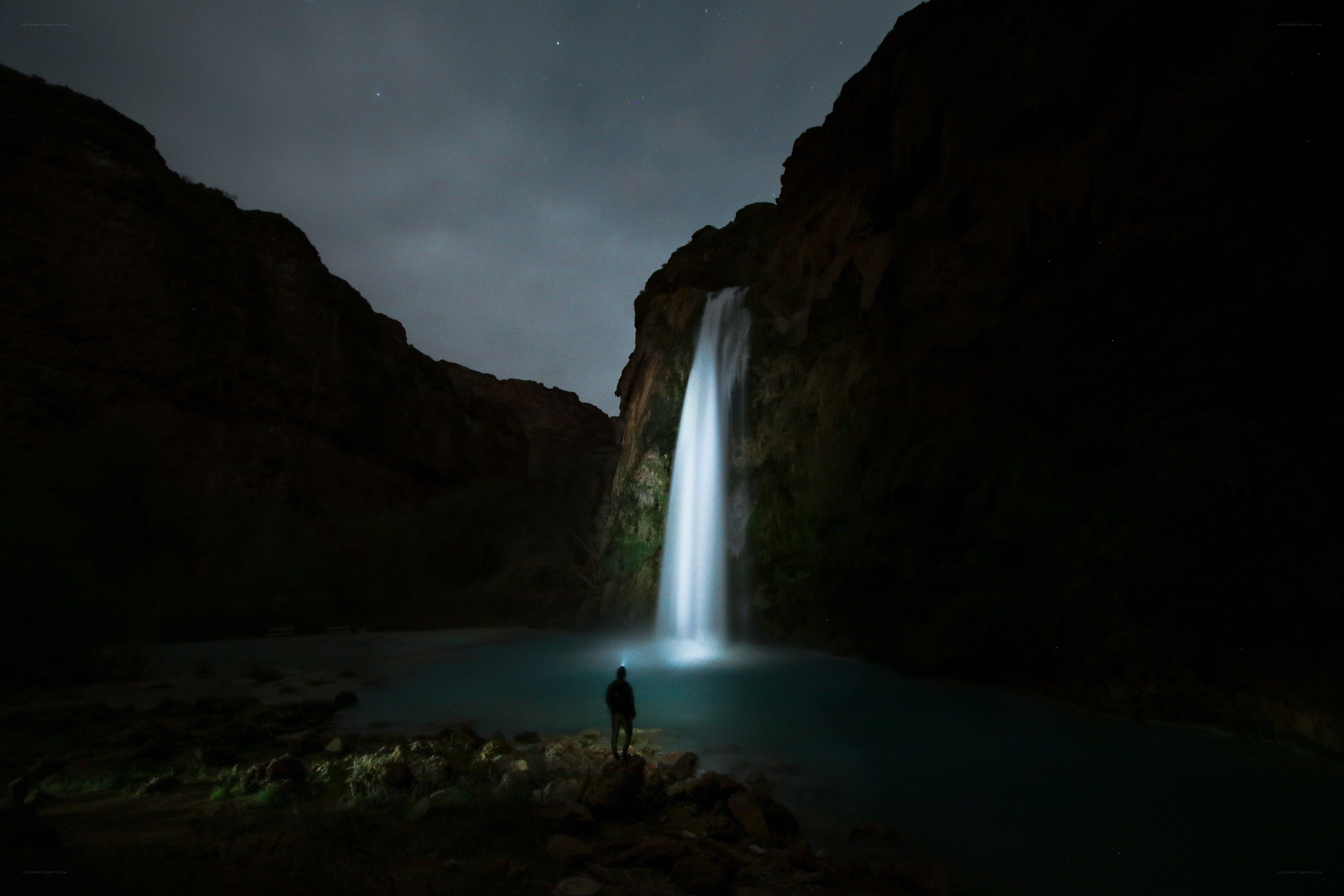 Person at night waterfall