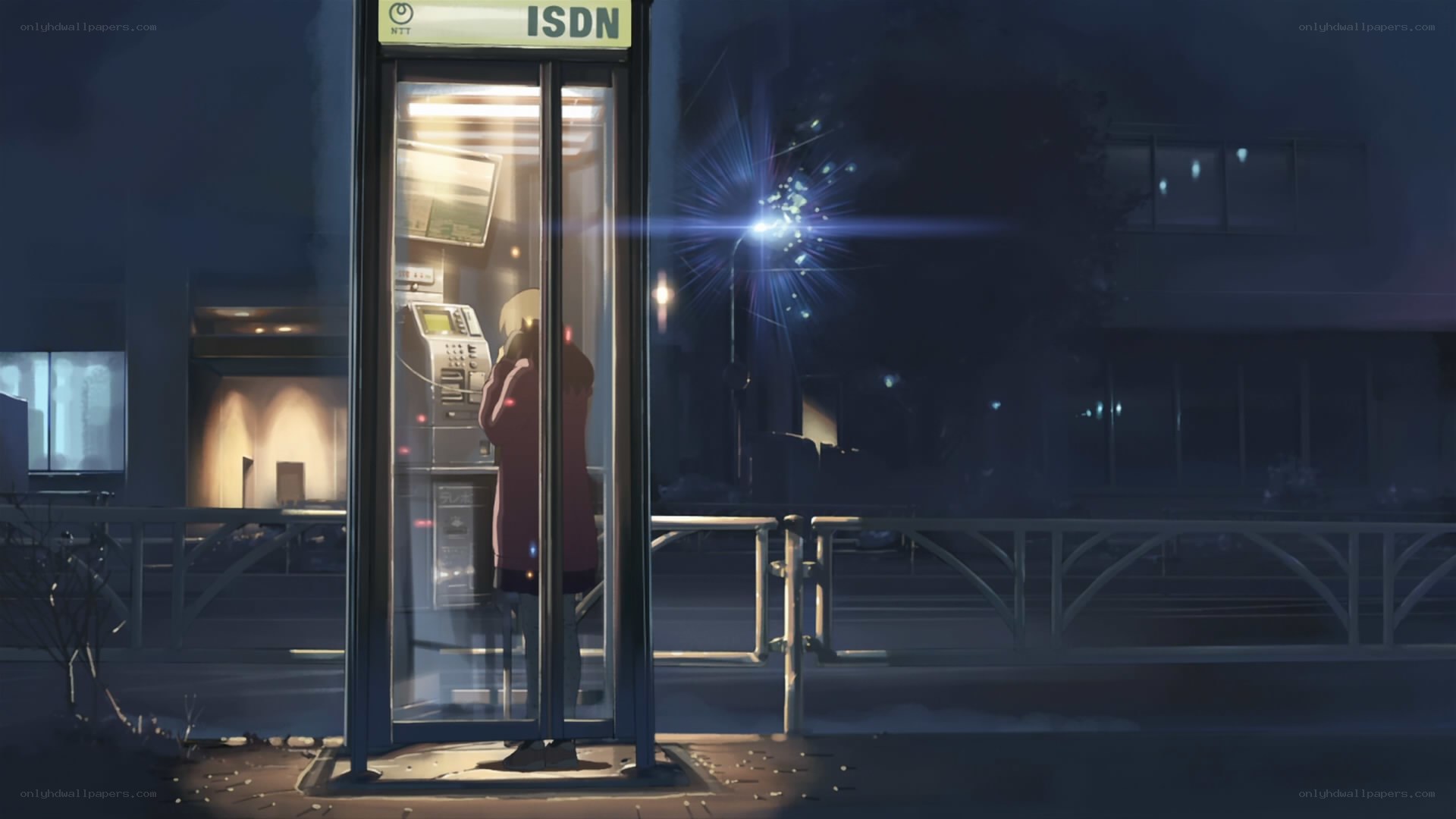 person at payphone at night