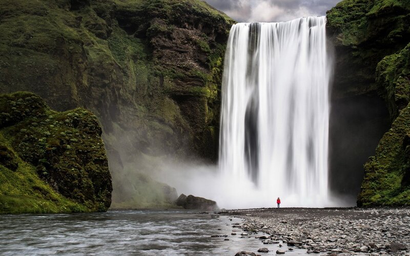 person at waterfall in Iceland