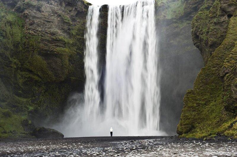 person at waterfall in Iceland