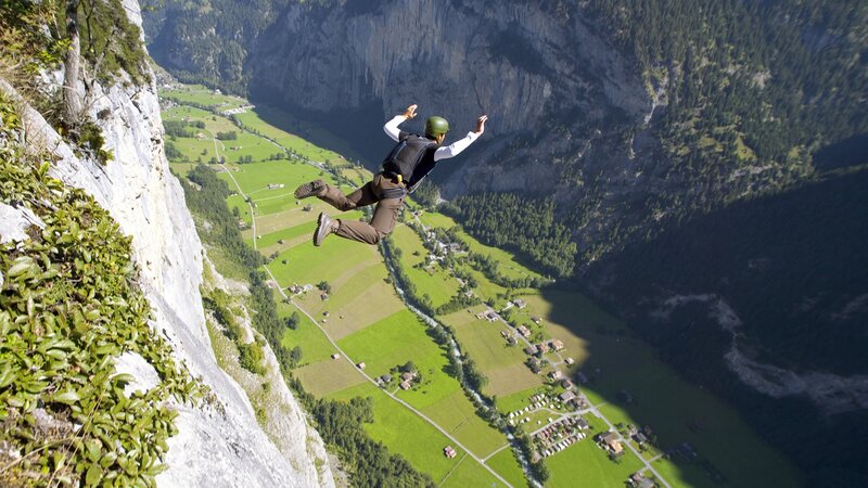 person base jumping from cliff