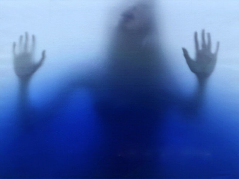 person behind frosted glass