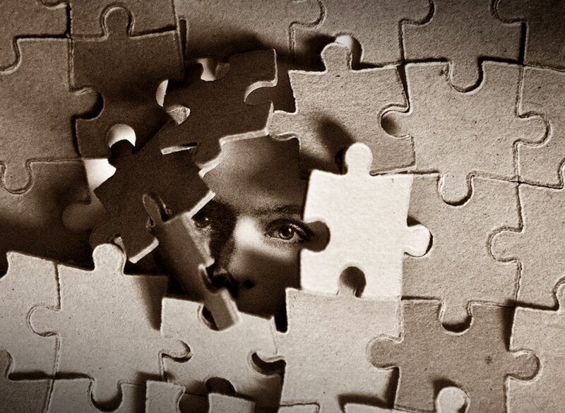 Person Behind Puzzle Pieces