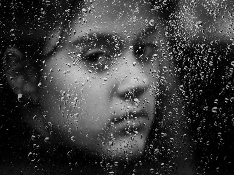 Person Behind Rain-covered Glass
