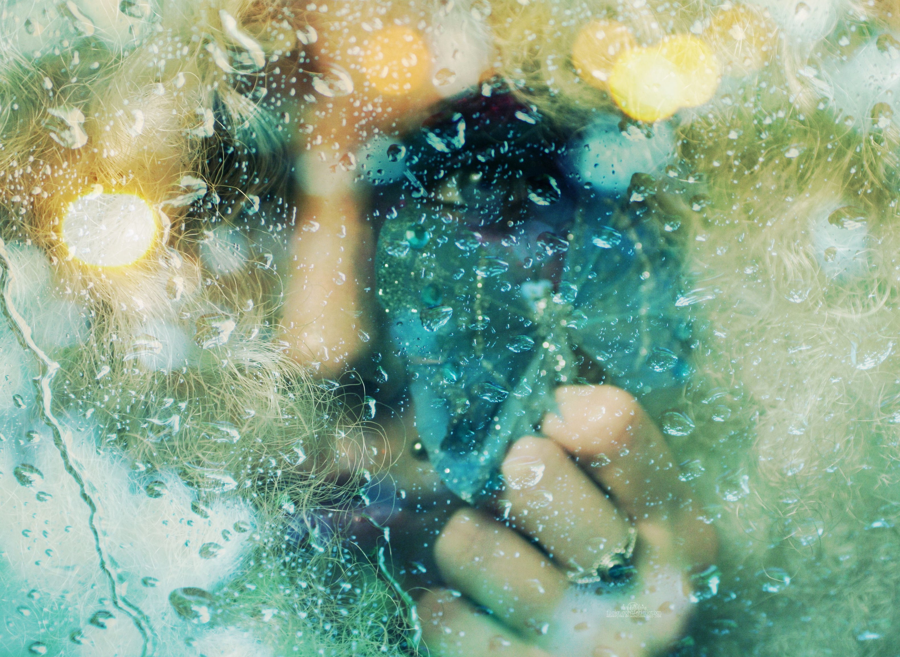 person behind wet glass