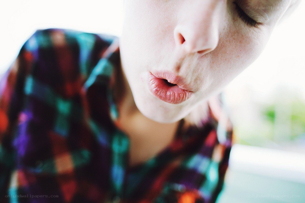 person blowing a kiss