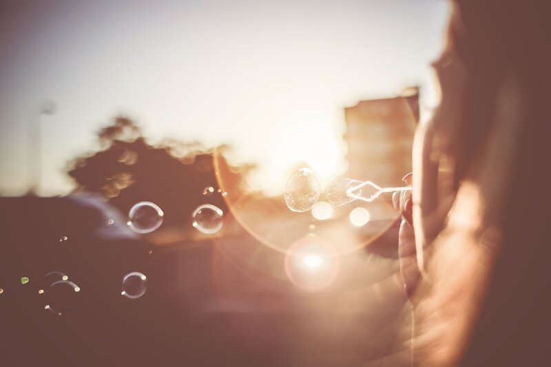 Person Blowing Bubbles — Brown