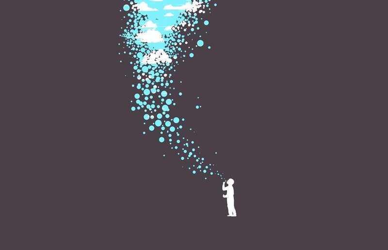 person blowing bubbles into sky