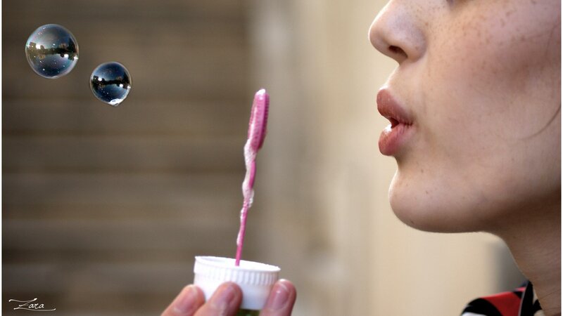 person blowing bubbles