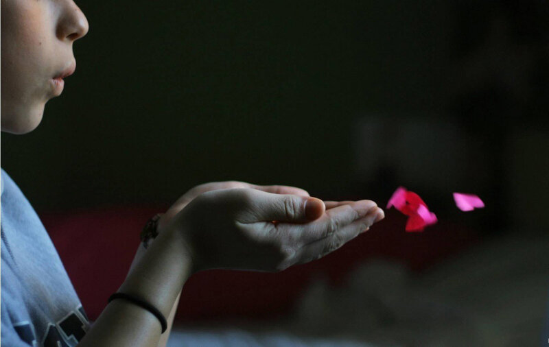 Person Blowing Flower Petals — Black