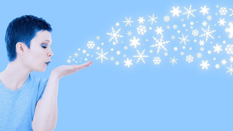 Person Blowing Snowflakes