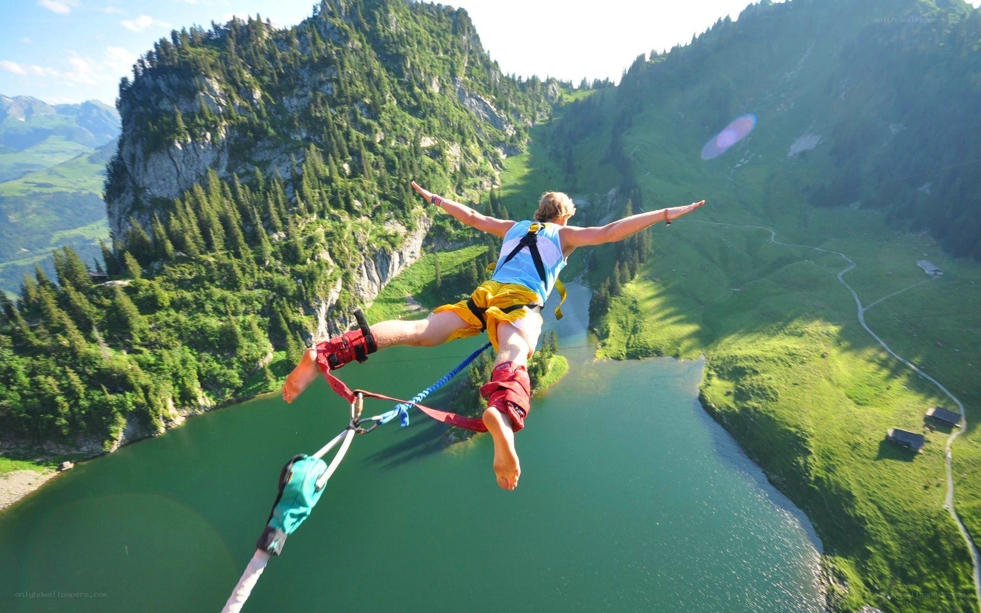 person bungee jumping over lake