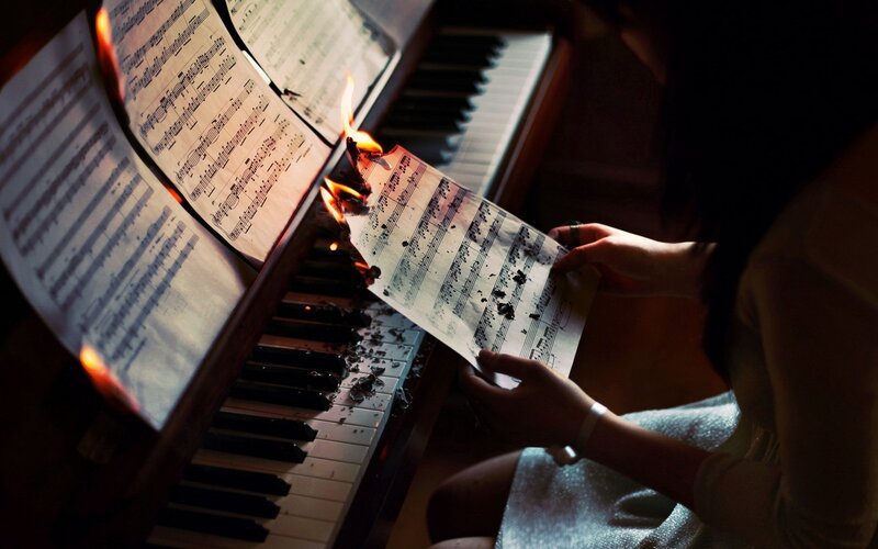 Person Burning Sheet Music