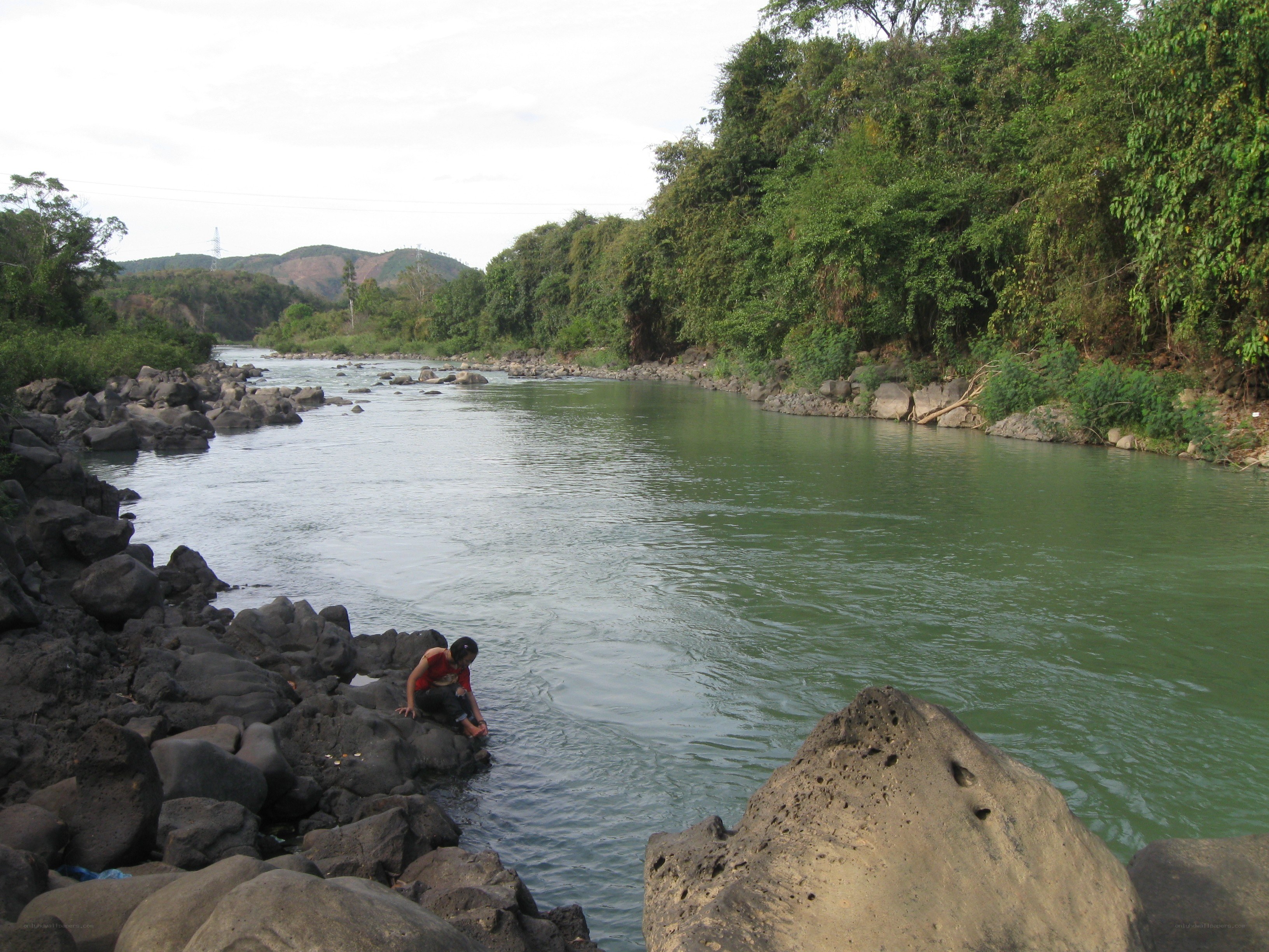 Person by a riverbank