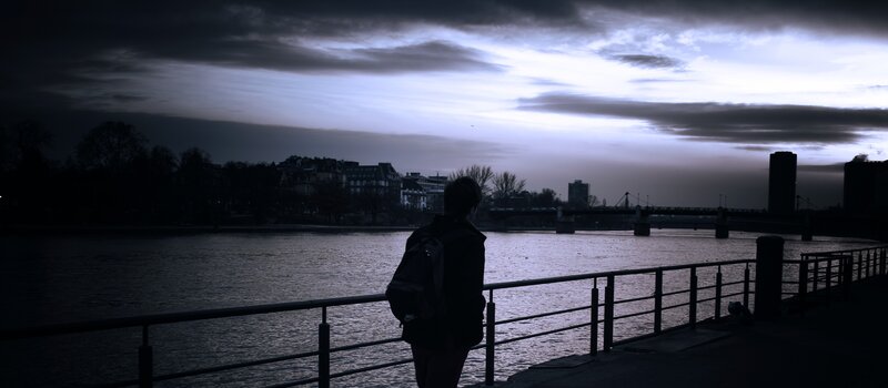 Person by the river at dusk