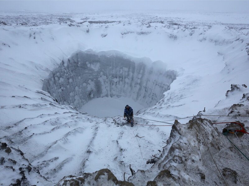 Person Climbing Ice Cave — White