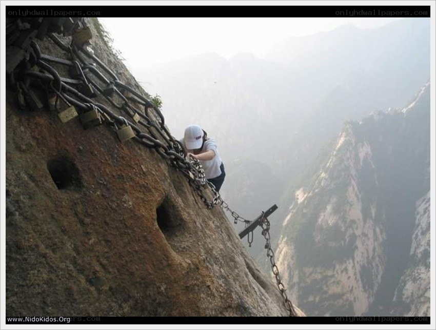Person climbing mountain chains