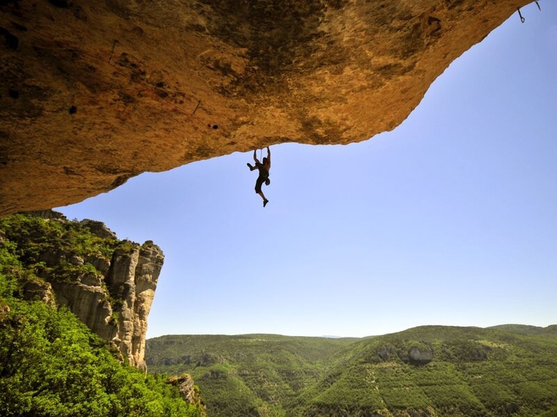 Person Climbing Rock Overhang
